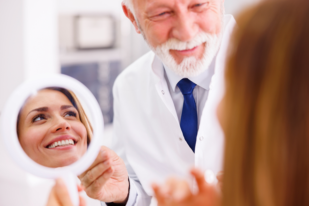 Dentist reviewing Invisalign smile results with patient
